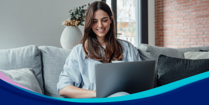 Young woman using a laptop on a sofa